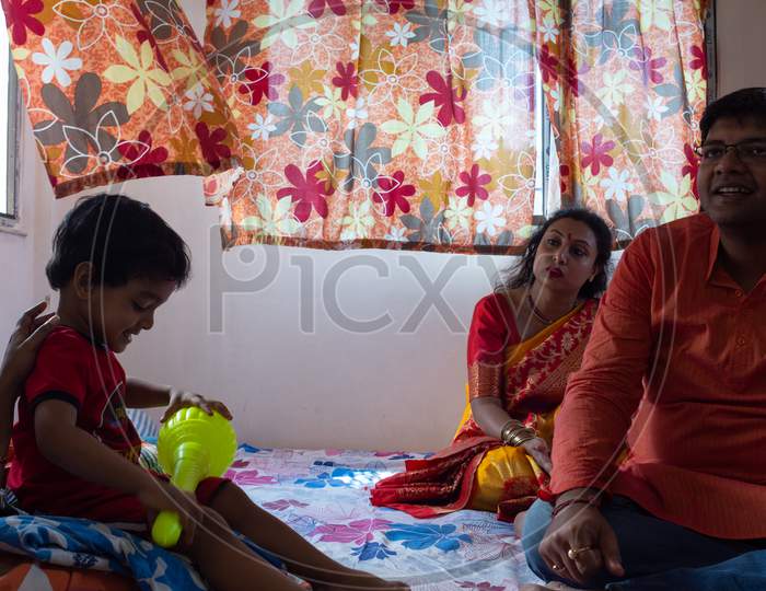 Indian family with child, parents and relatives enjoying and playing together