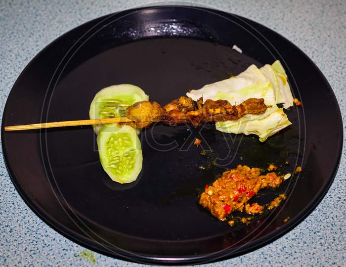 Indonesia food: chicken skin satay with penyet chili sauce