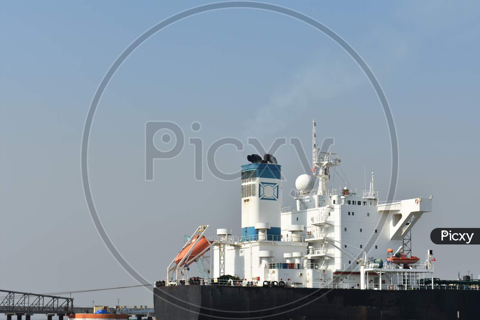 A White Merchant Ship Standing In A Port