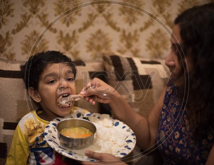 Bengali Indian mom trying to feed her baby boy playing with him