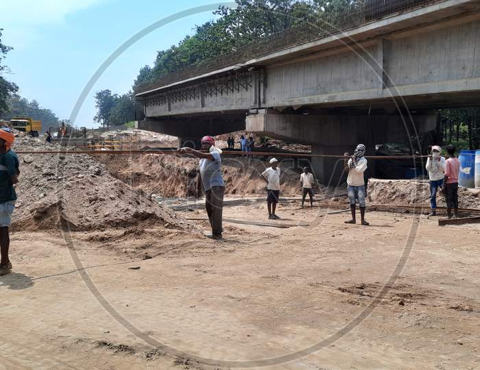 The labourers are working on the National Highway fourlane construction.