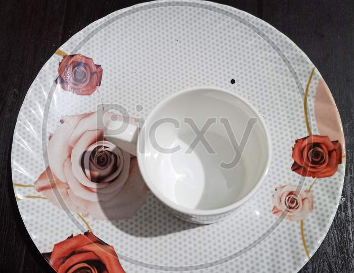 Empty cup of tea/coffee with beautiful plate.