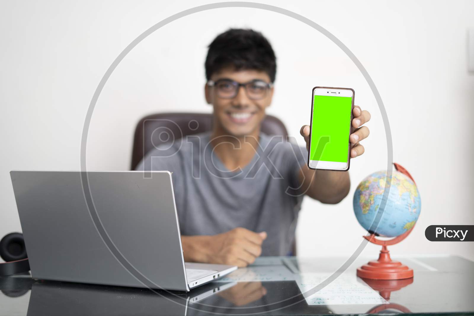 Young Indian Boy Holding A Phone With Green Screen.