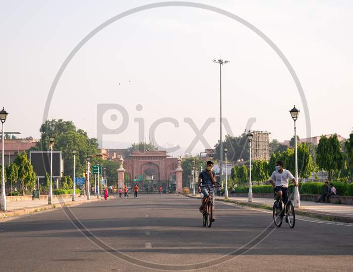 Boys, wearing mask, cycling in the morning