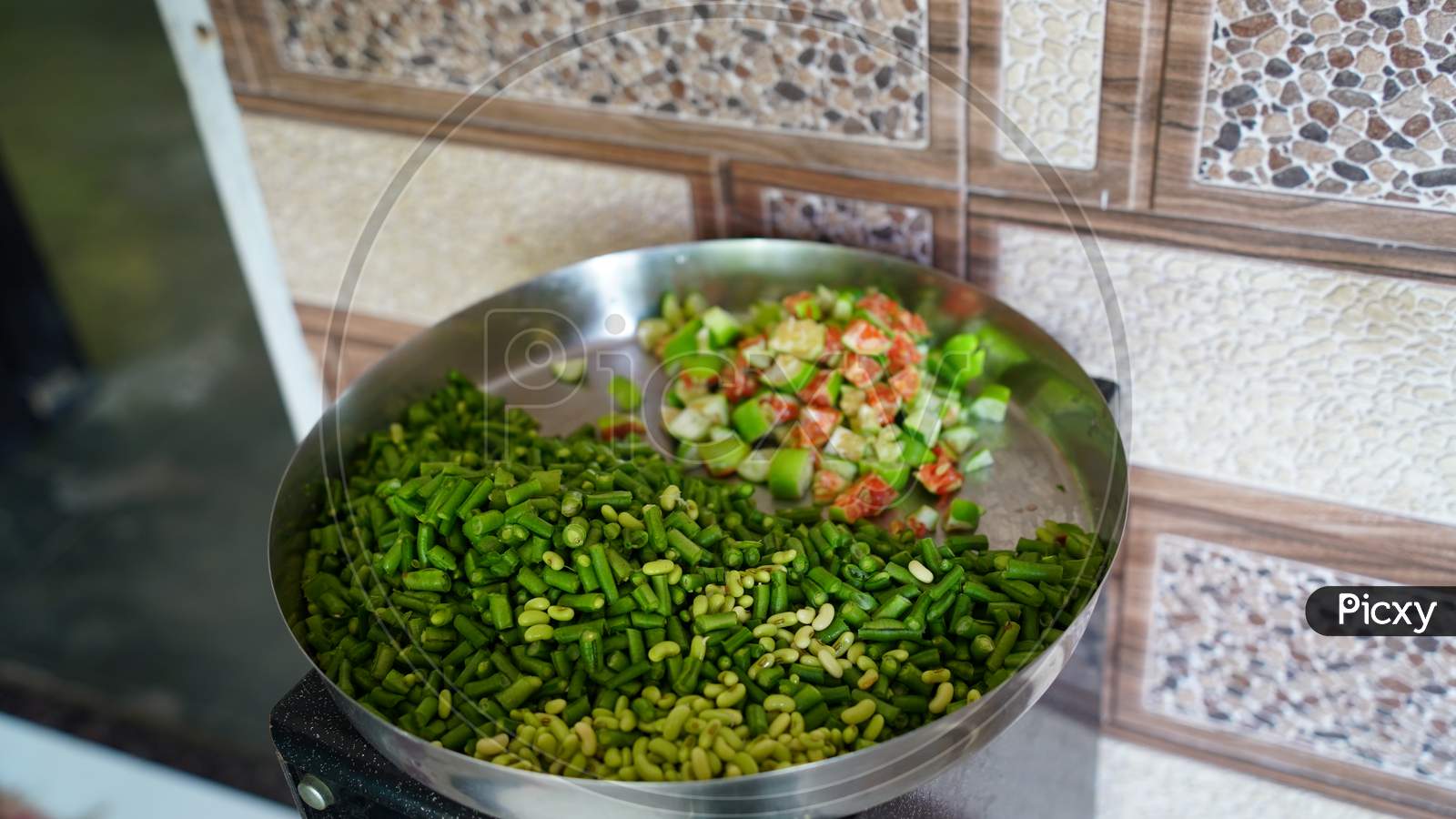 Fresh And Chopped Green Vegetables In A Plate In The Kitchen.