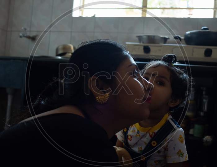 Indian child playing with her mother