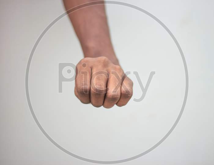 Stone Paper Seser Symbol - Male Showing Stone Sign Hand Isolated On White Background..Man Close All The Hand Fingers.