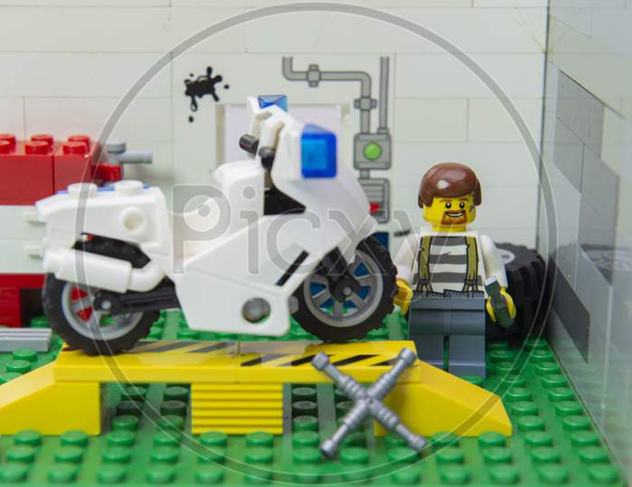 Florianopolis, Brazil. September 19, 2020: Grease-Dirty Mechanic Minifigure Repairing A Motorcycle In His Auto Repair Shop. Motorcycle In Need Of Repair. Copy Space. Selective Focus.
