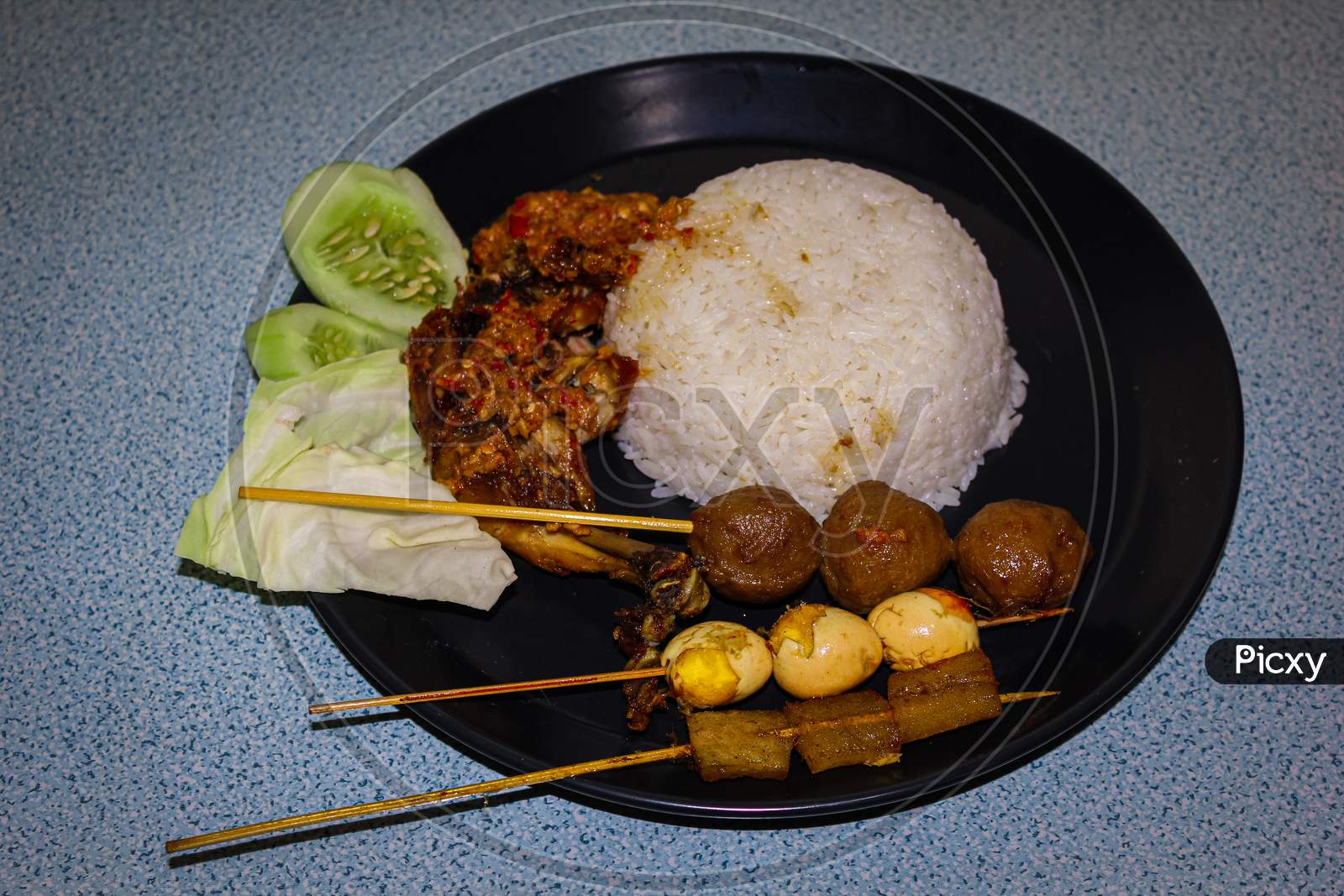 Complete penyet sauce fried chicken nasi rames (indonesian food)