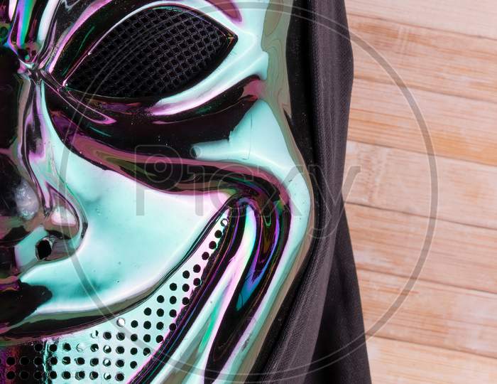 Iridescent Mask Close Up On Wooden Background