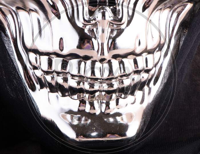 Silver Grin Mask Close Up On Black Background