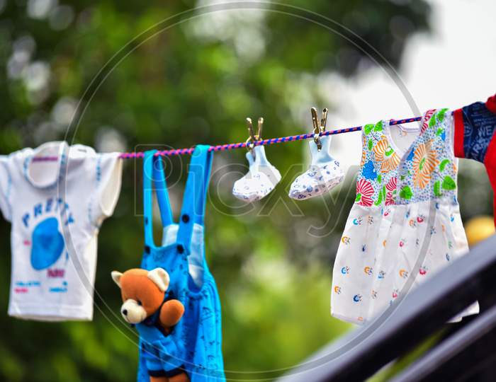 Baby Clothes Hanging On The Clothesline.