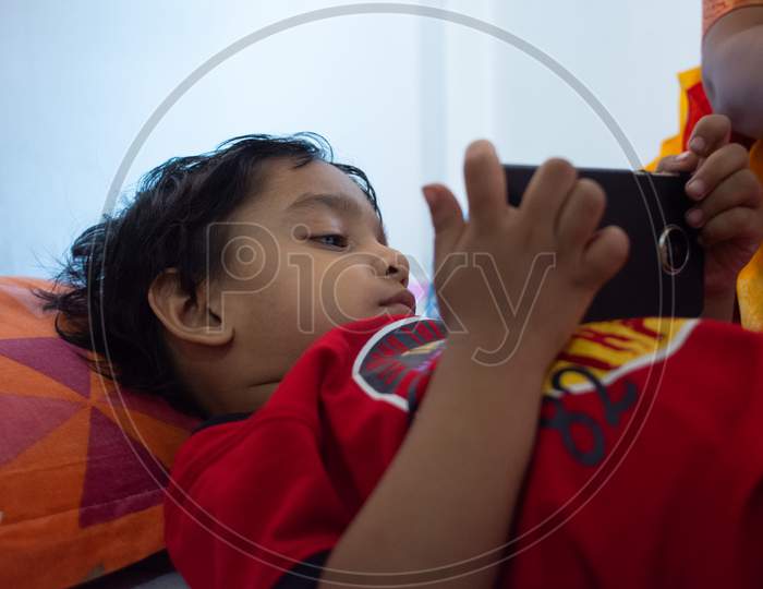 Indian child playing with phone