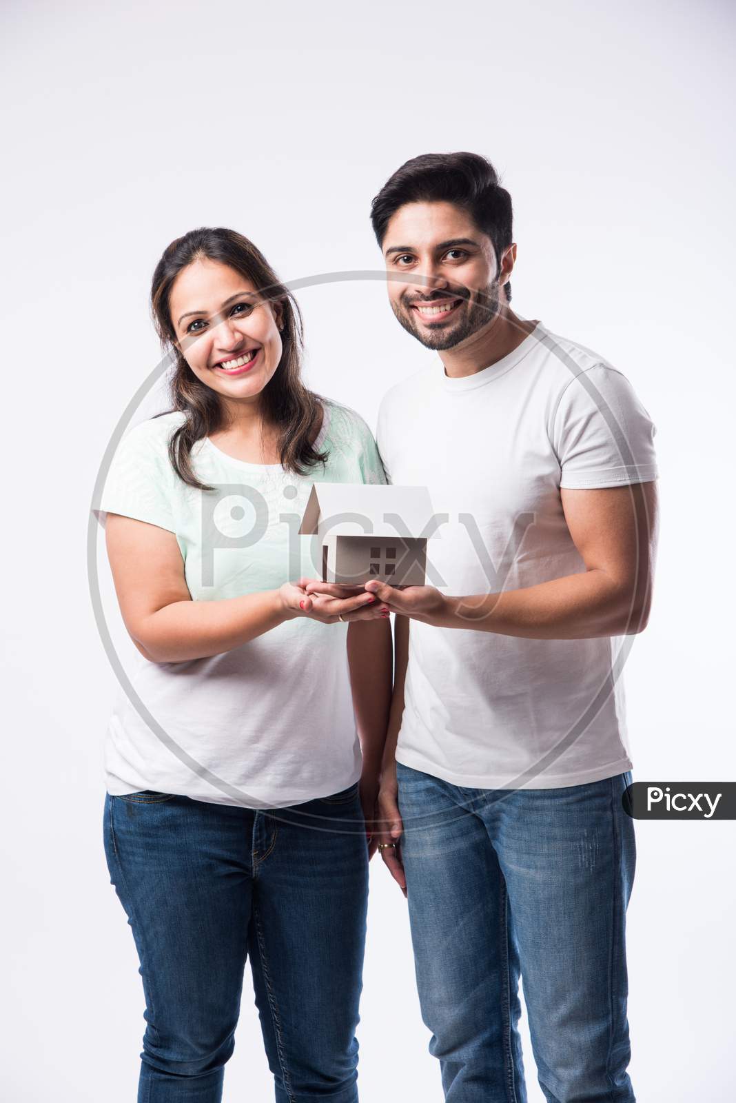 Concept Real Estate Housing And Young Indian Couple Family - Husband Wife Holding 3D Paper Model
