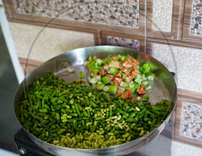 Fresh And Chopped Green Vegetables In A Plate In The Kitchen.