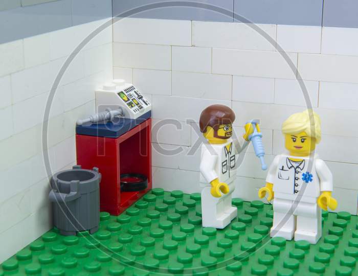 Florianopolis, Brazil. September 19, 2020: Nurse Minifigure Applying Covid-19 Test Vaccine To A Doctor. Health Workers And Elderly People Belong To The Risk Group. Copy Space. Selective Focus.