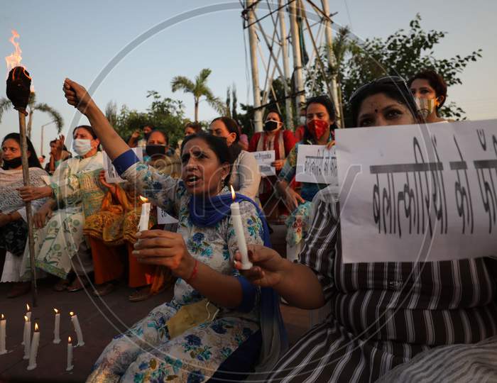 Mahila Congress light candles  and  raise slogans during a protest against the death of a 19-year-old Dalit woman in Jammu ,1 october,2020.