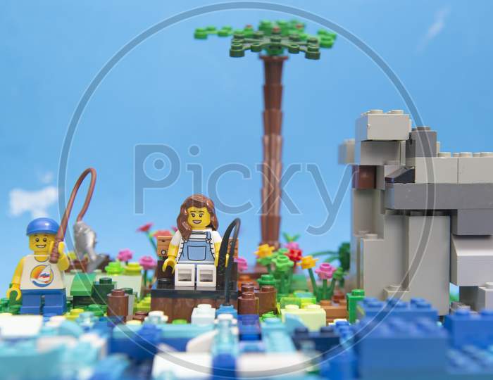 Florianopolis, Brazil. September 20, 2020: Minifigure Of Boy Fishing In Lake Next To His Mother. Concept Of Family Moment Without Technology, Increasingly Rare. Selective Foocus. Copy Space.