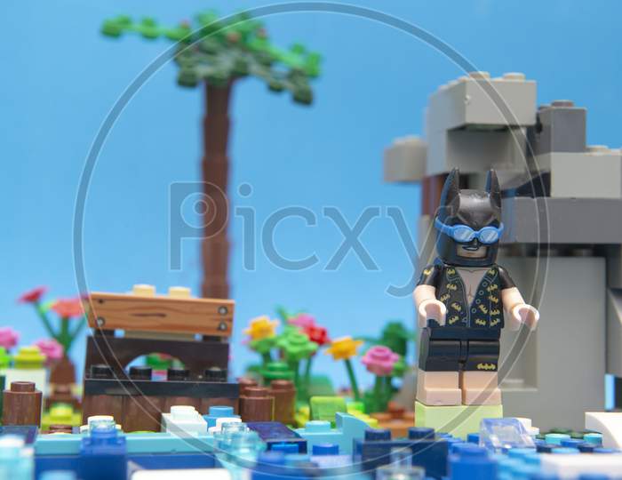 Florianopolis, Brazil. September 20, 2020: Batman Minifigure On The Edge Of A Lake Getting Ready To Take A Dip On His Summer Vacation. Concept That Even Heroes Need To Take Time To Take It Easy.