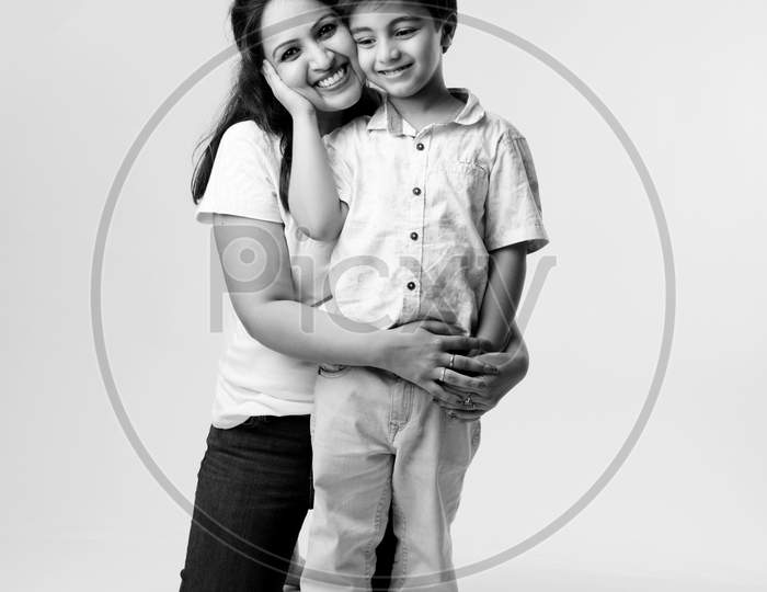 Indian Pretty Young Mother And Little Boy Or Son Embracing On White Background
