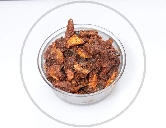 Dry hot spicy red chillies with garlic curryon white background