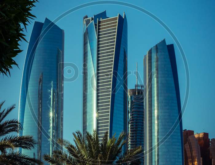Abu Dhabi , Uae - 10 October 2020 : Capital City Of United Arab Emirates With Emirates Flag, Etihad Towers, Adnoc Head Office,Emirates Palace And Cityscape
