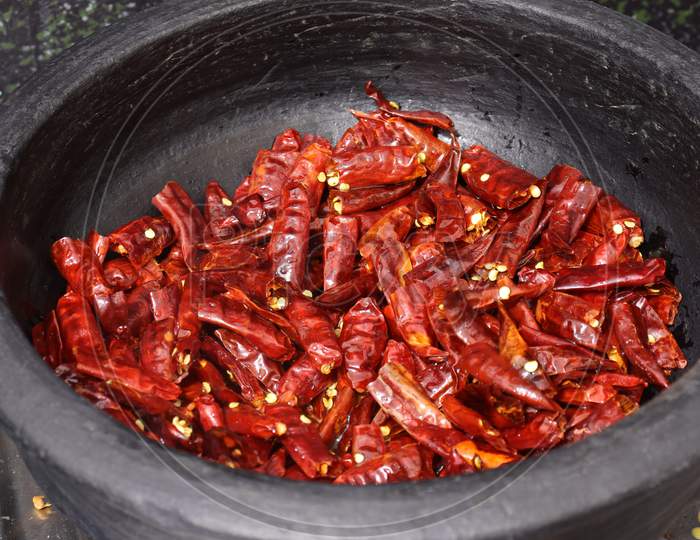 Dry hot red chillies on white background from top view.