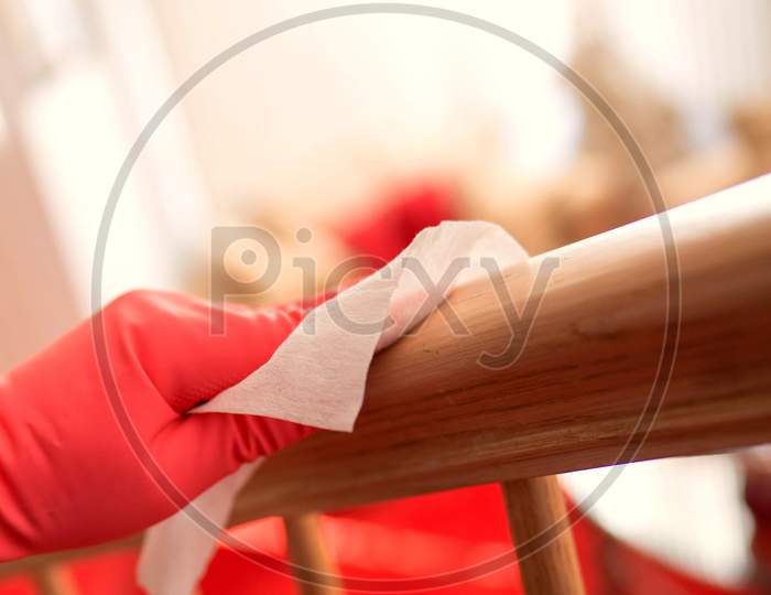 A Young Woman Disinfect And Clean The Wooden Railing Against Covid 19