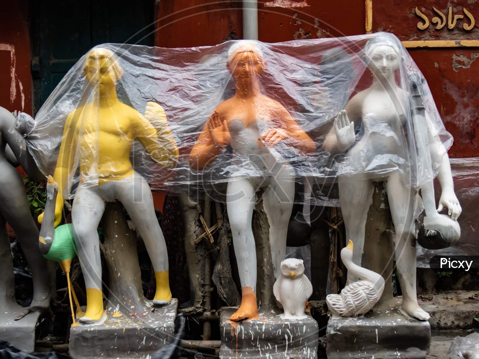 Idols Covered By Plastic To Protect From Rain.