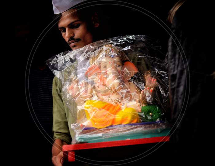A Ganesh devotee taking home GaneshJi from ganesh workshop