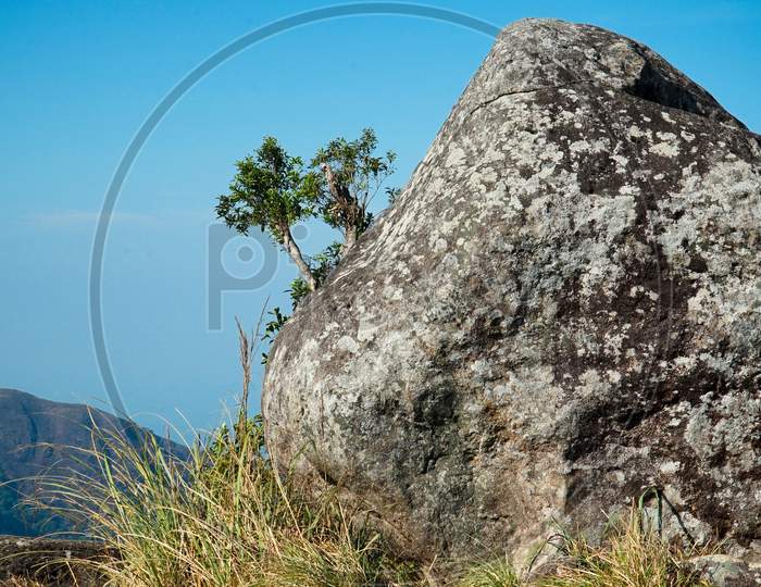 Image Of Big Rock In A Mountain With Bluish Sky Background
