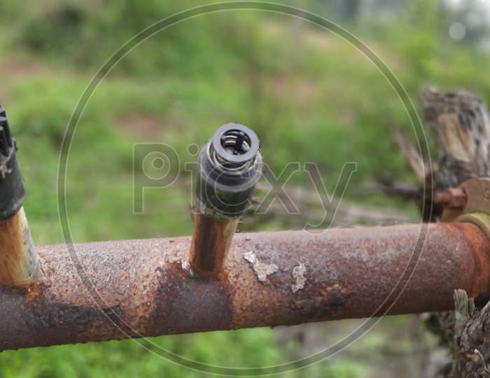 old rusted motor pump connect to plastic pipe with air valves