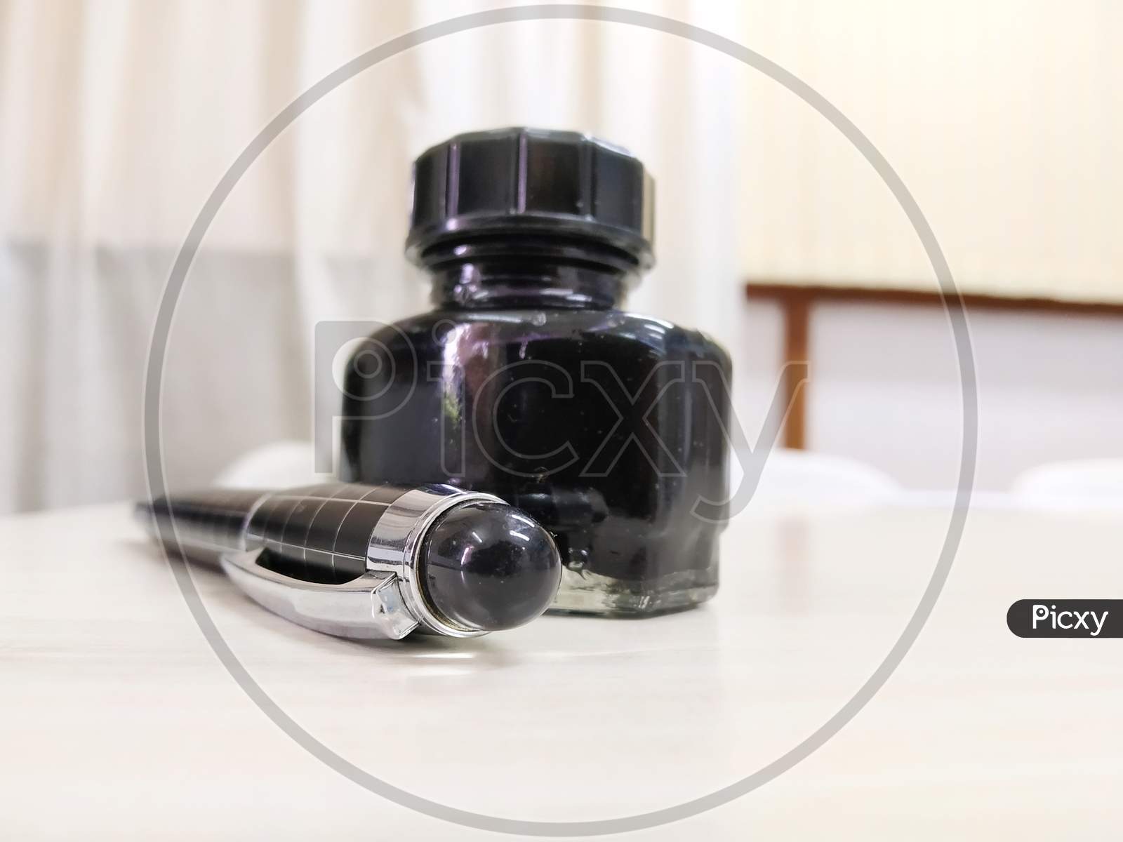 A Ink Pen With Black Bottle
