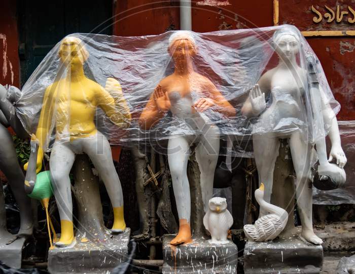 Idols Covered By Plastic To Protect From Rain.