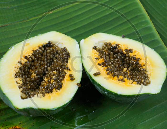 Half Ripe Papaya Fruit On Leaf Of Musa