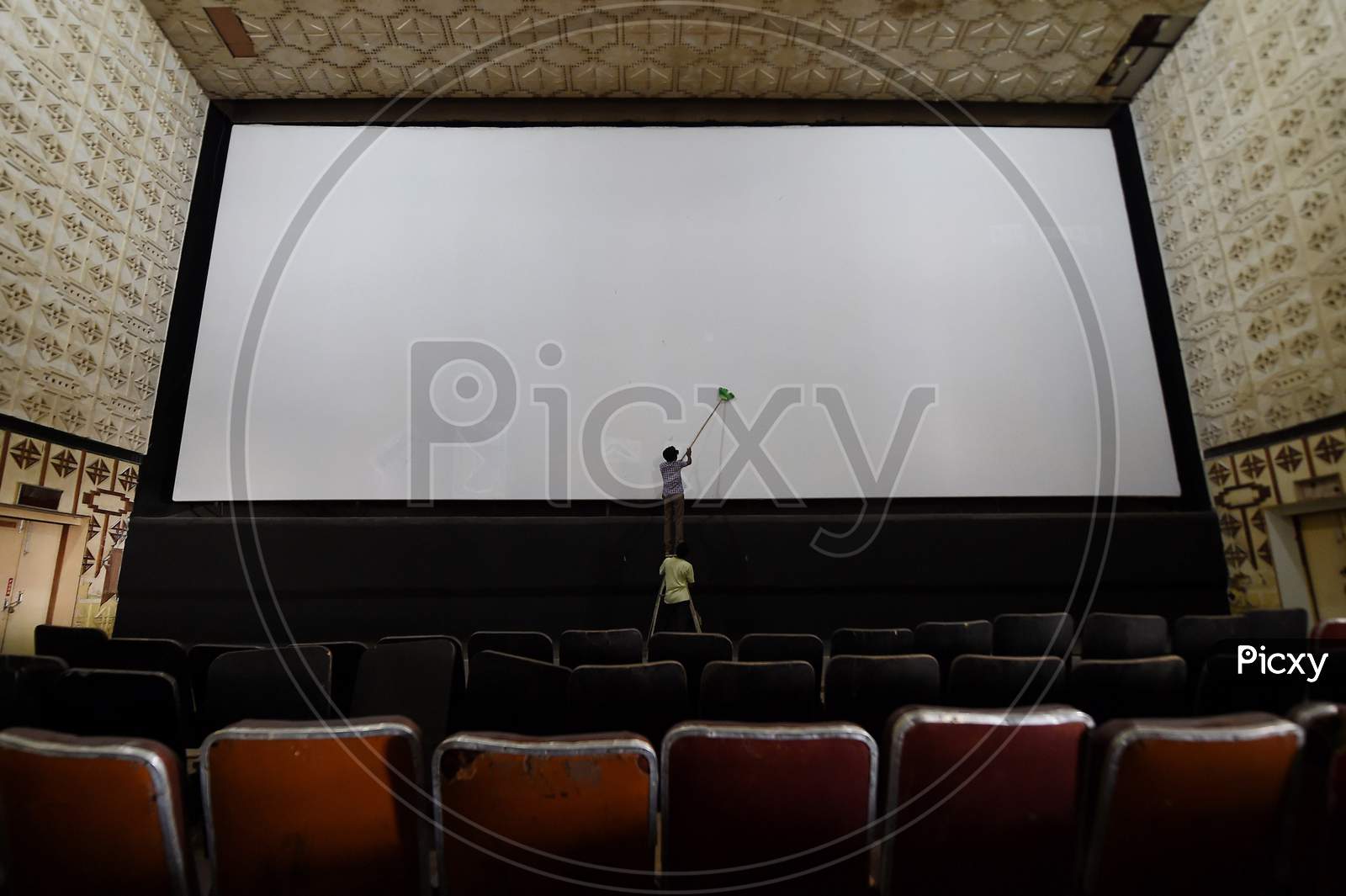 A Worker Cleans A Cinema Hall Ahead Of Its Reopening, During Unlock 5, Amid The Coronavirus Pandemic, In Chennai, Fridayday, Oct.9, 2020