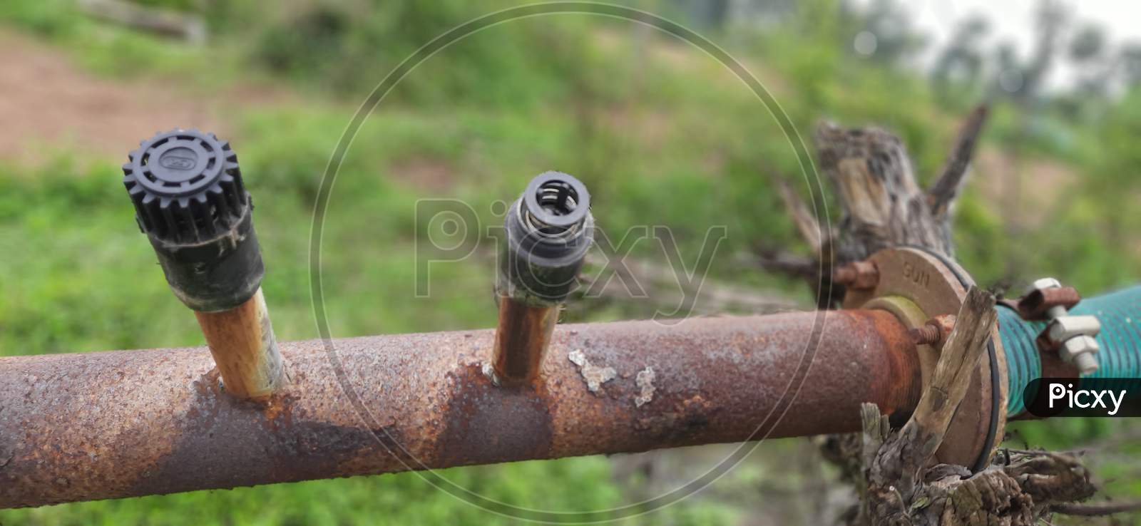 old rusted motor pump connect to plastic pipe with air valves