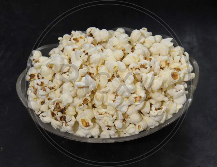 Heap of salted popcorn, isolated on white background.