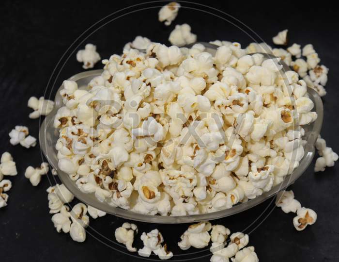 Heap of salted popcorn, isolated on white background.