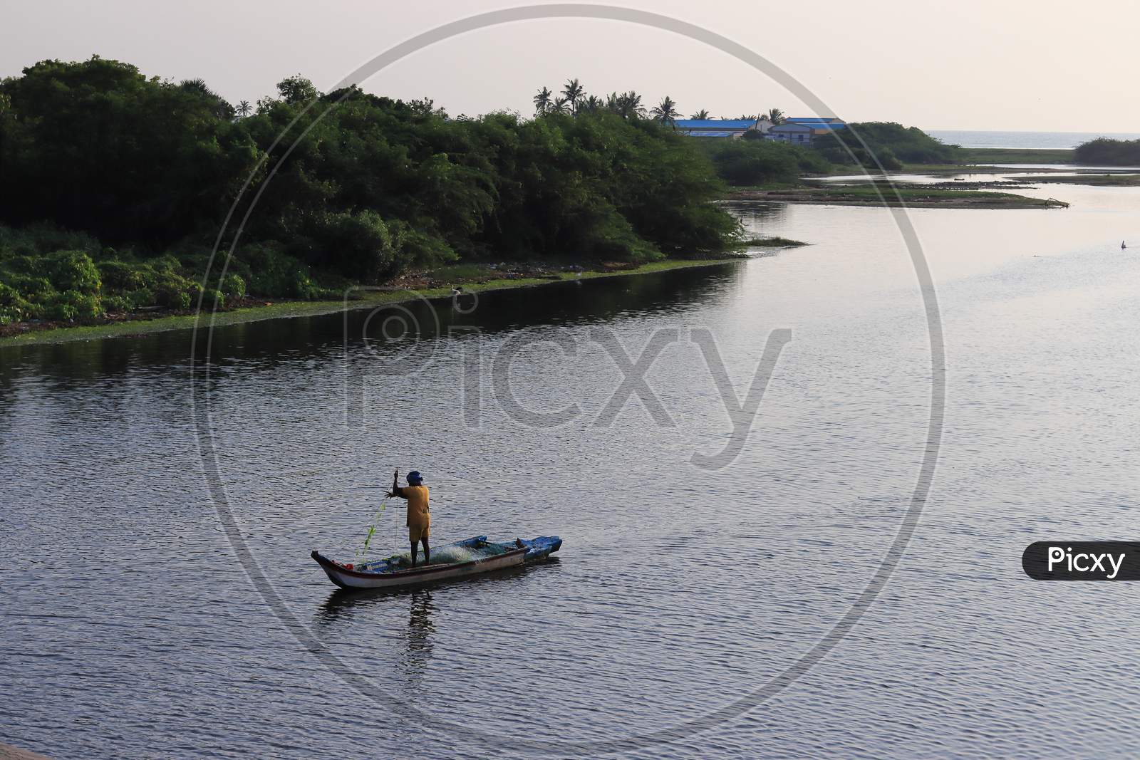 In The Morning, A Fisherman Rode In A Wooden Boat To Catch Fish From The Lake Of Water.