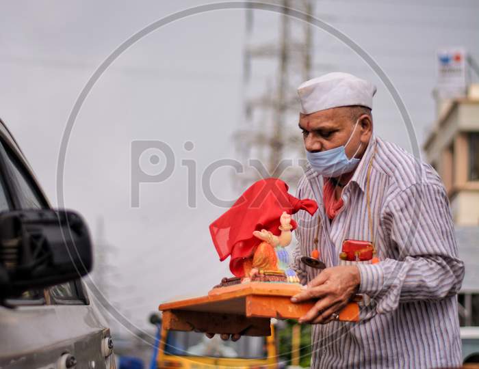 An old man taking home Ganesh idol, Ganpati bappa