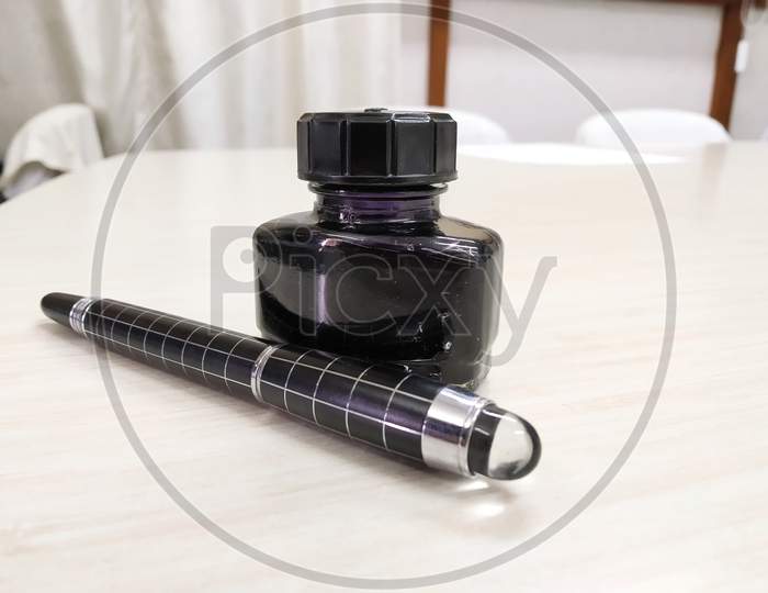A Ink Pen With Black Bottle