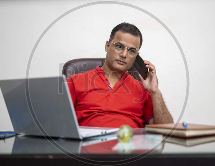Technology, Remote Job And Lifestyle Concept - Happy Indian Man In Glasses With Laptop Computer Working At Office.