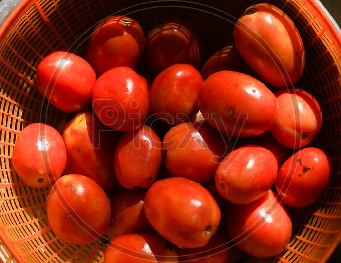 Close Up Image Of Tomatoes In Plastic Basket.