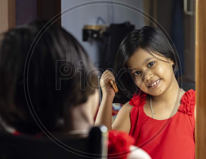 A Cute Girl In Front Of Mirror