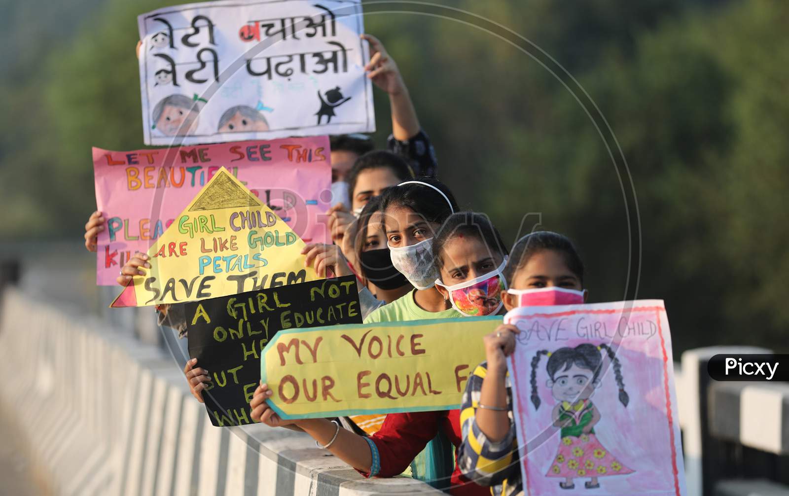 A Group of girls hold playcards ahead of International girls child day in Jammu ,10 october.2020.