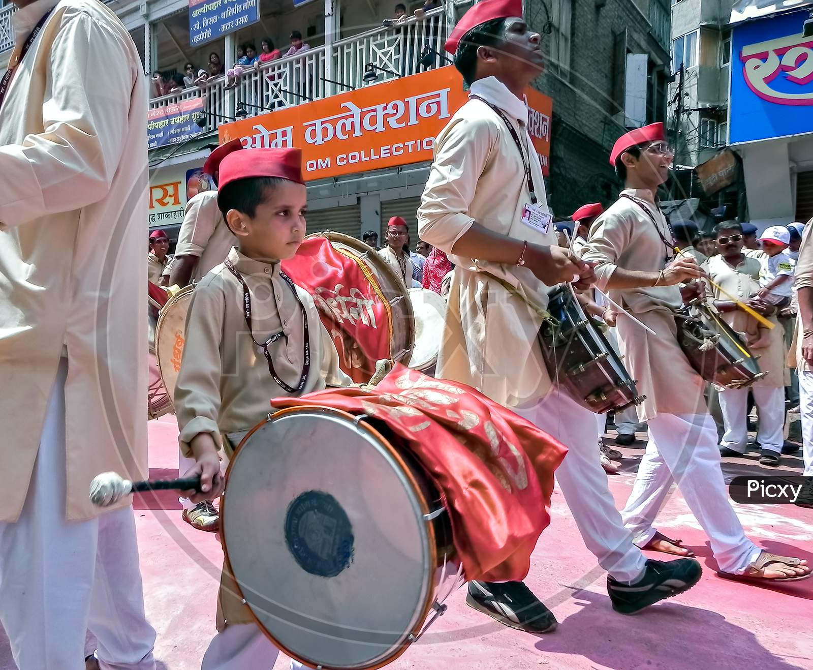 Little Boy With Red Cap , With Elder Boys, Beating Huge Traditional Dhol.