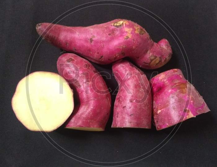 Sweet Pink Potatoes On The Black Background Close Up Photo