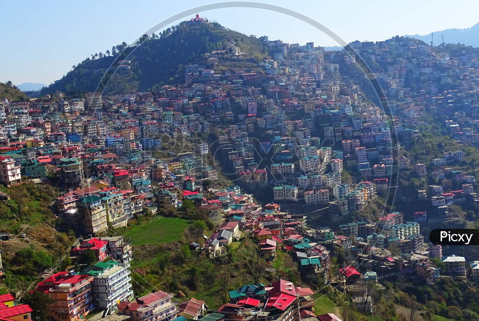 Landscape view of beautiful city Shimla situated in himachal pradesh in the mountain range of great himalayas at sunrise time with houses, trees and birds
