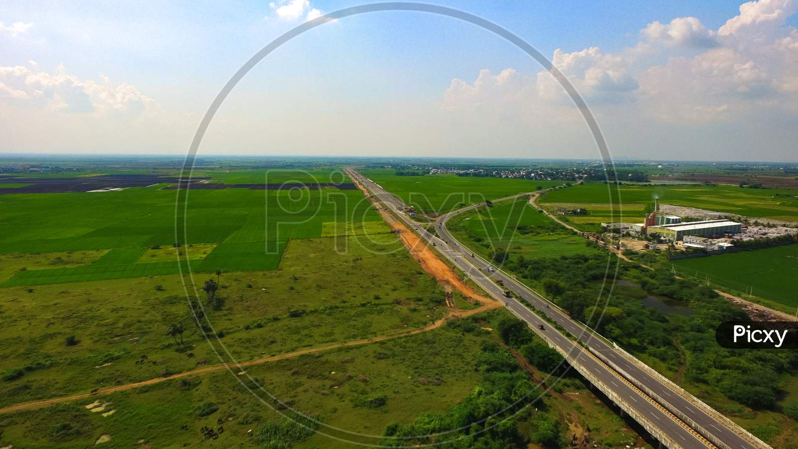 National Highway with green rice fields Vijayawada Andhra Pradesh State, India